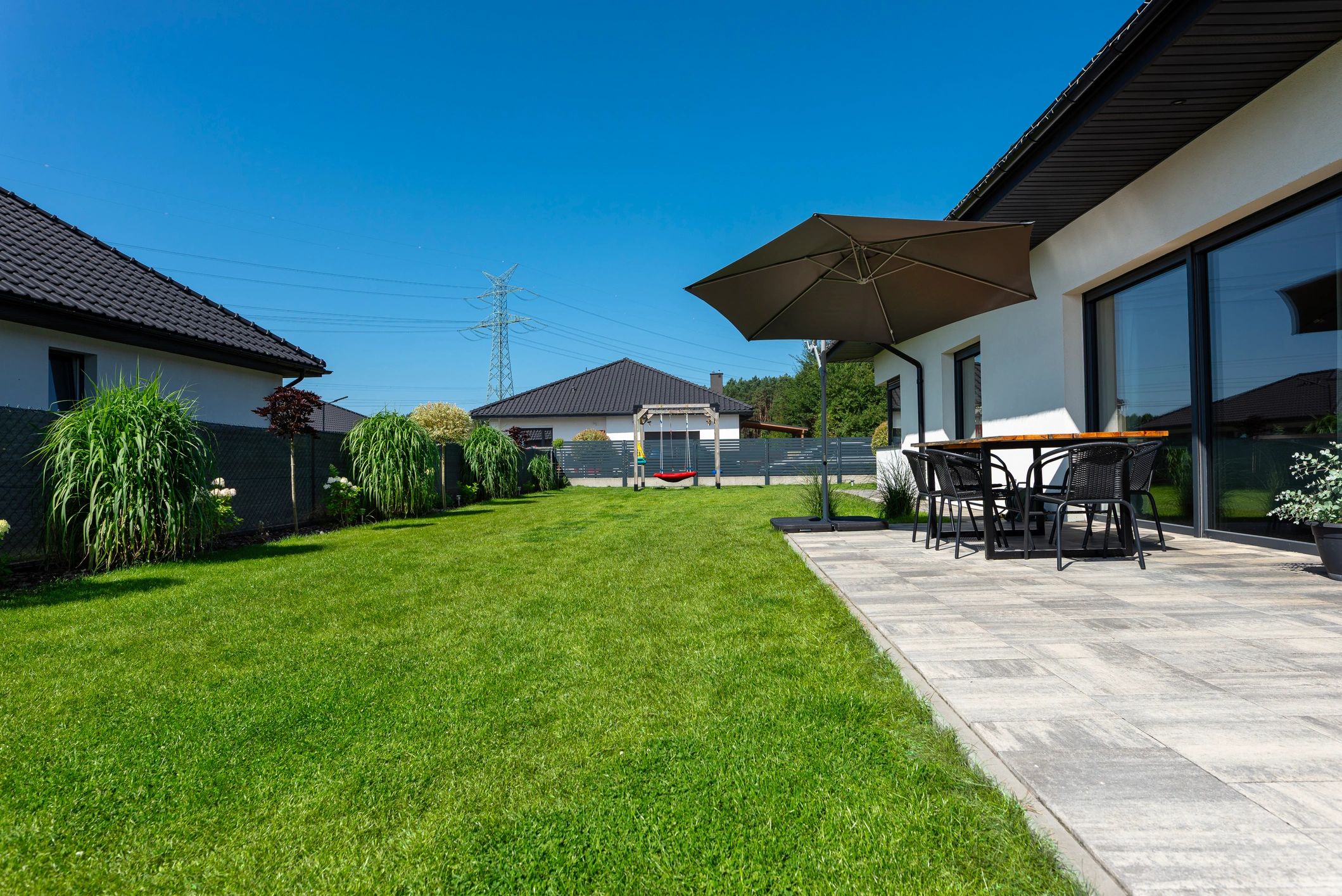 Backyard patio with brick pavers and outdoor seating